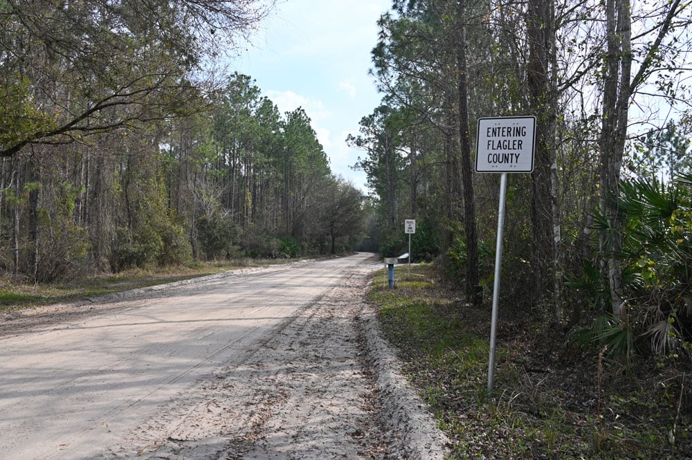 Old Brick Road at the Flagler-St. Johns County line. Flagler County has been coating the 111-year-old brick road with sand to reduce damage from logging trucks, the principal users of the public road. (© FlaglerLive)