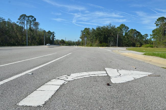 The turning lane on Old Kings Road has been there for years. It just needs a development to point to. The Palm Coast City Council just made it easier to sell the land to a potential apartment or condo builder. (© FlaglerLive)