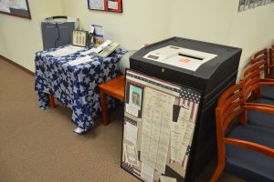 An old voting machine--the sort voters are familiar with--next to other museum pieces, including the Kennedy-Nixon election ballot, and ballots from the hanging chad era. Click on the image for larger view. (© FlaglerLive)