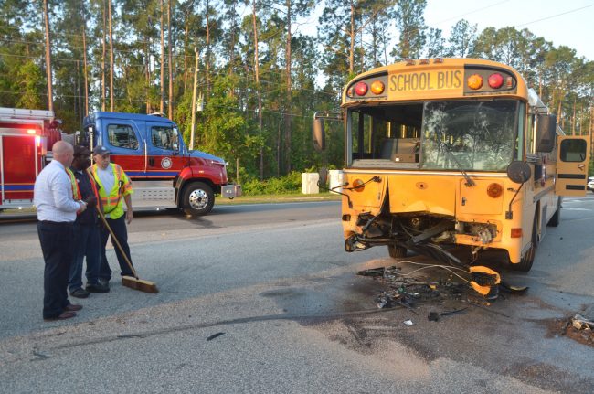 The school bus after the SUV was removed. Superintendent Jacob Oliva is to the left. Click on the image for larger view. (© FlaglerLive)