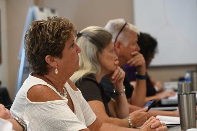 The school district's Patty Bott, in the foreground, School Board Attorney Kristy Davin, and Dave Freeman, the district's chief of operations. (© FlaglerLive)