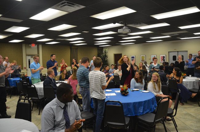 An ovation for the 40 students who made up the 2017 IB Class at FPC, 31 of whom earned the IB diploma, a 74 percent success rate that exceeds the world average by three points. They returned to FPC's Bistro on Dec. 21 for a diploma remittance ceremony. (© FlaglerLive)