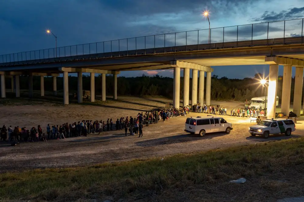 Migrants that have crossed the Rio Grande surrender to U.S. Border Patrol near an area known as Rincon. From here they will be transported to a processing center. (CBP)