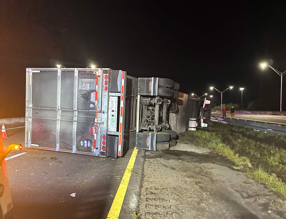 The overturned semi in the first crash, on the State Road 100 bridge. (© FlaglerLive)