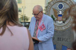 County Commissioner Dave Sullivan, speaking this morning, has seen his family devastated by breast cancer's toll. (c FlaglerLive)