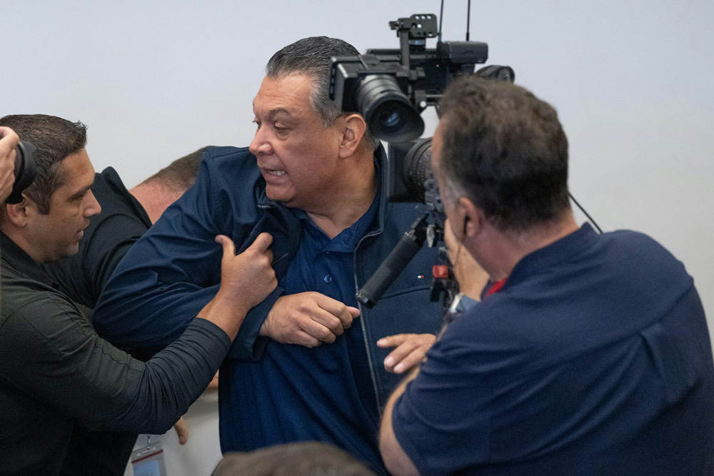 U.S. Sen. Alex Padilla of California is pushed out of the room after he interrupted Homeland Security Secretary Kristi Noem during a news conference in Los Angeles on June 12, 2025.