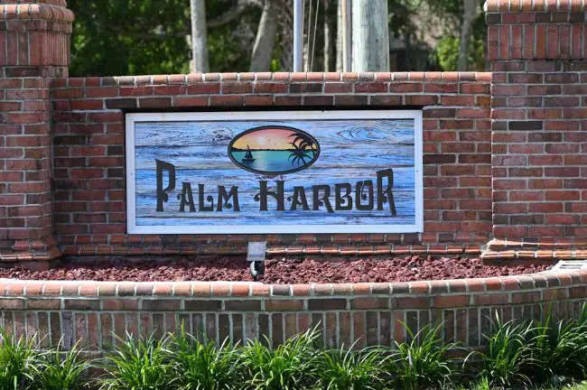 The entrance to palm Harbor, a sign refurbished by ken Bryan and his wife after it'd become dilapidated--like the stormwater system now. (© FlaglerLive)
