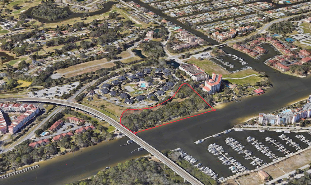 The acreage the county will acquire is marked off in red, just north of the Hammock Dunes Bridge. (Google Earth)