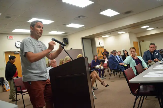 James Bellino, the pastor at Bunnell’s Church on the Rock, speaking to the Public Safety Coordinating Council this morning, with the council's chairman, Joe Mullins, to the right. (© FlaglerLive)