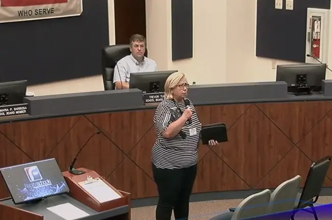 Jeanine Clontz, a pastor at Flagler Beach United Methodist Church, delivering a prayer before pitching her church to the audience at Tuesday's Flagler County School Board meeting.