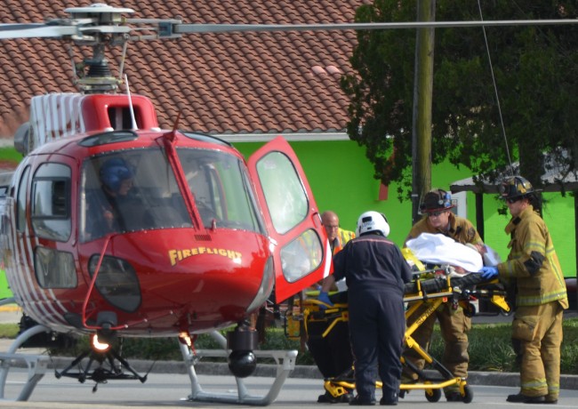 One of the two patients being loaded on Fire Flight. Click on the image for larger view. (© FlaglerLive)