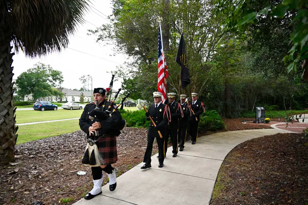 The Palm Coast Fire Department's Lt. Patrick Juliano, left, his outstanding services to our country with the Palm Coast Fire Department and as a bagpiper, for which he performs for many community organizations. (© FlaglerLive)