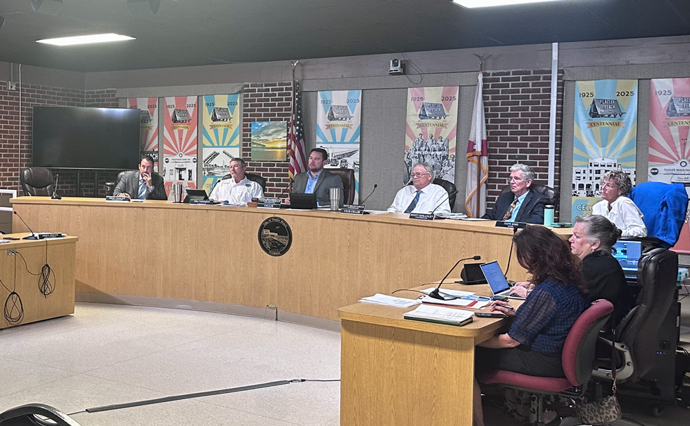 Flagler Beach Mayor Patti King, furthest to the right n the dais, addressed her colleagues on Palm Coast Mayor Mike Norris's position regarding the beach-management plan last night. (© FlaglerLive)