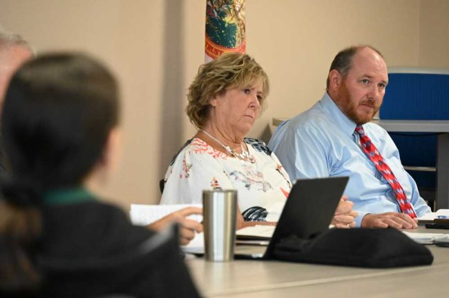 The school district's Patty Bott, left, and attorney Chris Wilson at the ILA working group's last meeting Wednesday--before the breakthrough, when their skeptical looks reflected the district's stance. (© FlaglerLive)