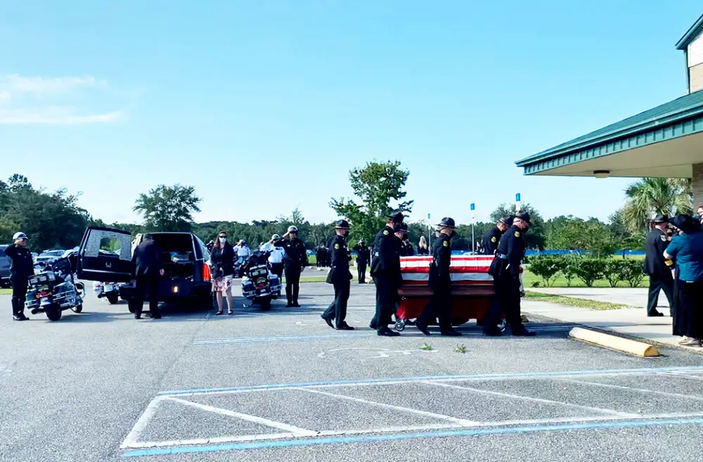 Deputy Paul Luciano's coffin as pallbearers approached First Baptist Church in Bunnell for this morning's service. (© FlaglerLive via FCSO video)