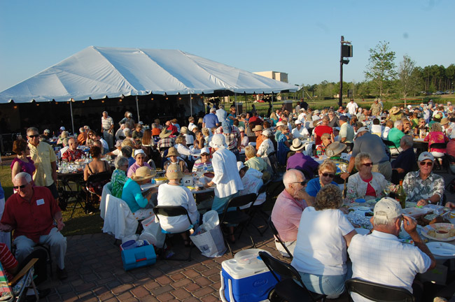 First the food, the wine, the beer, then the music, the wine, the beer, and more, with the Jacksonville Symphony Orchestra under the bog tent at Town Center. (© FlaglerLive)