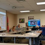 Assistant Superintendent Paul Peacock, right, outlines a plan to remake the Belle Terre Swim and Racket Club as a school site that would accommodate several district programs while possibly still preserving some of the club's amenities. The board members studied their options. (© FlaglerLive)