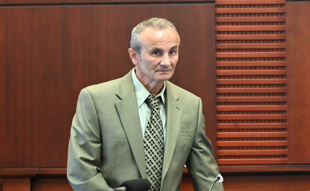 Dr. Pedrag Bulic readying to testify in a Flagler County court case, one of some 200 to 300 times he did so in his career as a medical examiner. (© FlaglerLive)