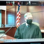 Flagler County Circuit Judge Terence Perkins holding a set of hearings by zoom recently: he presided from his courtroom, defendants were connected by video from the jail, lawyers and others by Zoom. (© FlaglerLive)