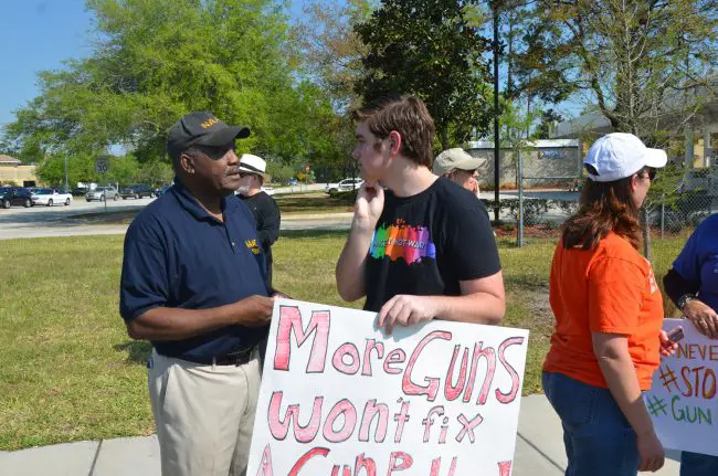 FPC's Tyler Perry Speaking with veteran demonstrator Sims Jones. Click on the image for larger view. (© FlaglerLive)