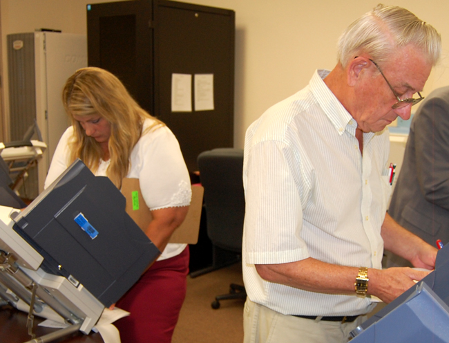 They're not seeing eye-to-eye on the budget again: Supervisor of Elections Kimberle Weeks and County Commission Chairman Alan Peterson. (© FlaglerLive)