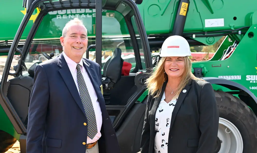 On the job: Flagler County Administrator Heidi Petito last month with Palm Coast Mayor David Alfin, during the filming of AdventHealth Palm Coast's groundbreaking on the hospital getting built on Palm Coast Parkway. Petito has developed working relationships with colleagues in local government. (© FlaglerLive)