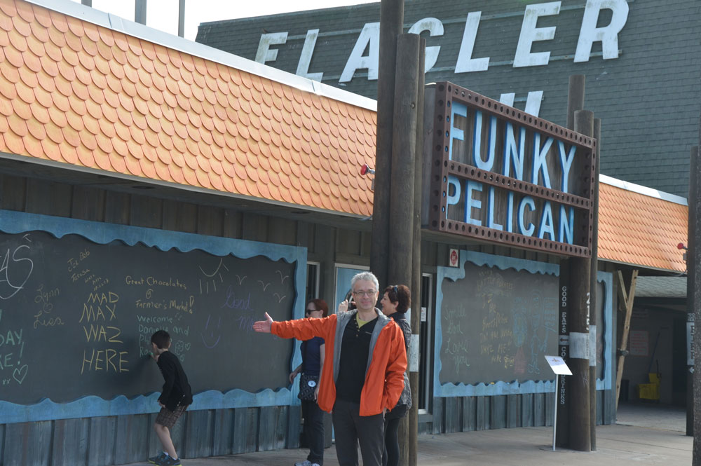 Philippe Waked of San Antonio, Texas, with his sister Danielle, of Montreal, behind him, outside the Funky Pelican some years ago. (© FlaglerLive)