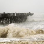 The Flagler Beach pier at sundown this evening was continuing to take a pounding from high waves as Hurricane Ian paralleled Flagler's shore. (© FlaglerLive)