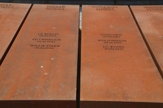 The lynched, including three in Putnam County, engraved on rust-colored pillars arranged like coffins. (© Pierre Tristam/FlaglerLive)