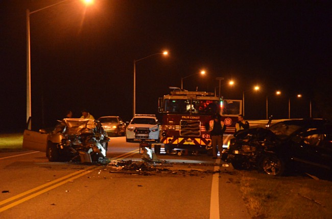 The scene on Palm Coast's Pine Lakes Parkway early this morning, as the medical examiner surveyed the wreckage. Click on the image for larger view. (c FlaglerLive)