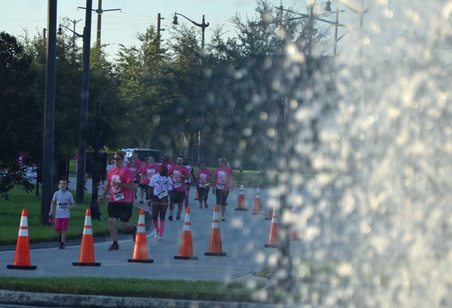 Some 1,000 runners took part in last October's Pink Army Run, with some participants seen above approaching the fountain in Town Center. (© FlaglerLive)