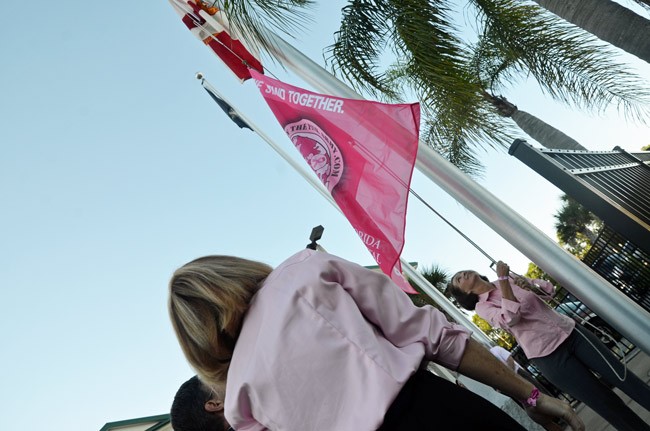 It's Pink Army flag-raising time, this morning at 8:15  in front of the Government Services Building. Commissioner Barbara Revels raised the flag last year. (© FlaglerLive)