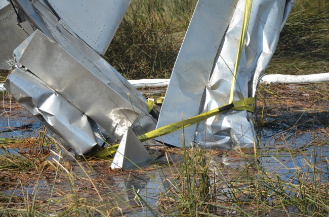 The straps are left over from Monday's four attempts to lift the plane from the air. Click on the image for larger view. (© FlaglerLive)