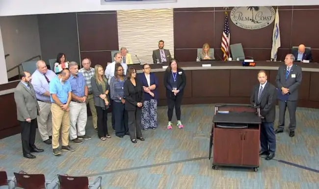 The men and women who keep planning boards, city councils and county commissions real: professional planners. Ray Tyner, second from right, the deputy development director in Palm Coast, spoke of the profession after Mayor David Alfin, right, proclaimed October National Planning Month. (© FlaglerLive via Palm Coast video)