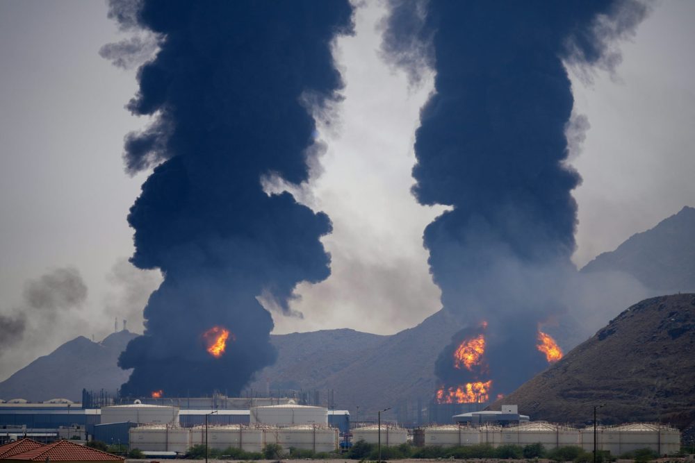 Plumes of smoke and fire rise after debris from an intercepted Iranian drone struck an oil facility, according to authorities, in Fujairah, United Arab Emirates, on March 14, 2026. 