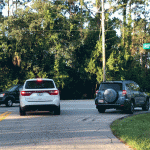The search for an alleged c ar-jacker focused on a quadrant immediately northeast of the area of Point Pleasant Drive and Royal Palms Parkway, where the man was apprehended early this morning. Early morning traffic, above, was as brisk as usual even within 45 minutes of an AlertFlagler notice about the armed car-jacker in the neighborhood. (© FlaglerLive)