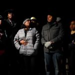 RowVaughn Wells, in gray jacket, mother of Tyre Nichols, who died after being beaten by Memphis police officers, is with friends and family members at the conclusion of a candlelight vigil for Tyre, in Memphis, Tenn., on Jan. 26, 2023.