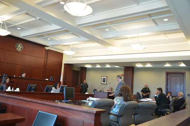 Jake Kaney, the attorney for Anne-Marie Shaffer (foreground), arguing before Flagler County Circuit Judge Dennis Craig Tuesday afternoon. John pollinger is at right. (c FlaglerLive)