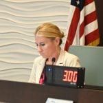 She reads the stacks of supporting material. (© FlaglerLive)