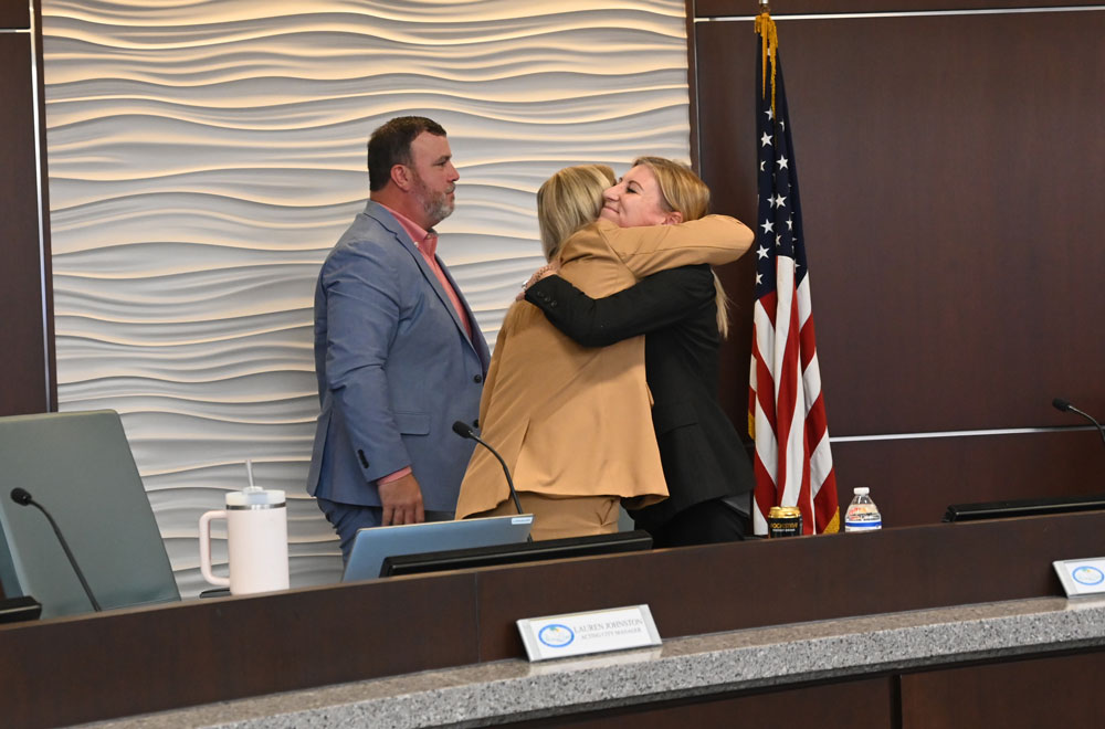 Council member Theresa Pontieri and Lauren Johnston, after Johnston received a recognition. Council member Ty Miller is to the left. (© FlaglerLive)
