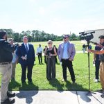 Palm Coast City Council member Theresa Pontieri, center, with Council member Ty Miller, right, during a visit by U.S. Rep. Randy Fine, left, at the city's Wastewater Treatment Plant 1 last August. Pontieri is seeking stronger local controls on the utility, should it become subject to a sale. (© FlaglerLive)