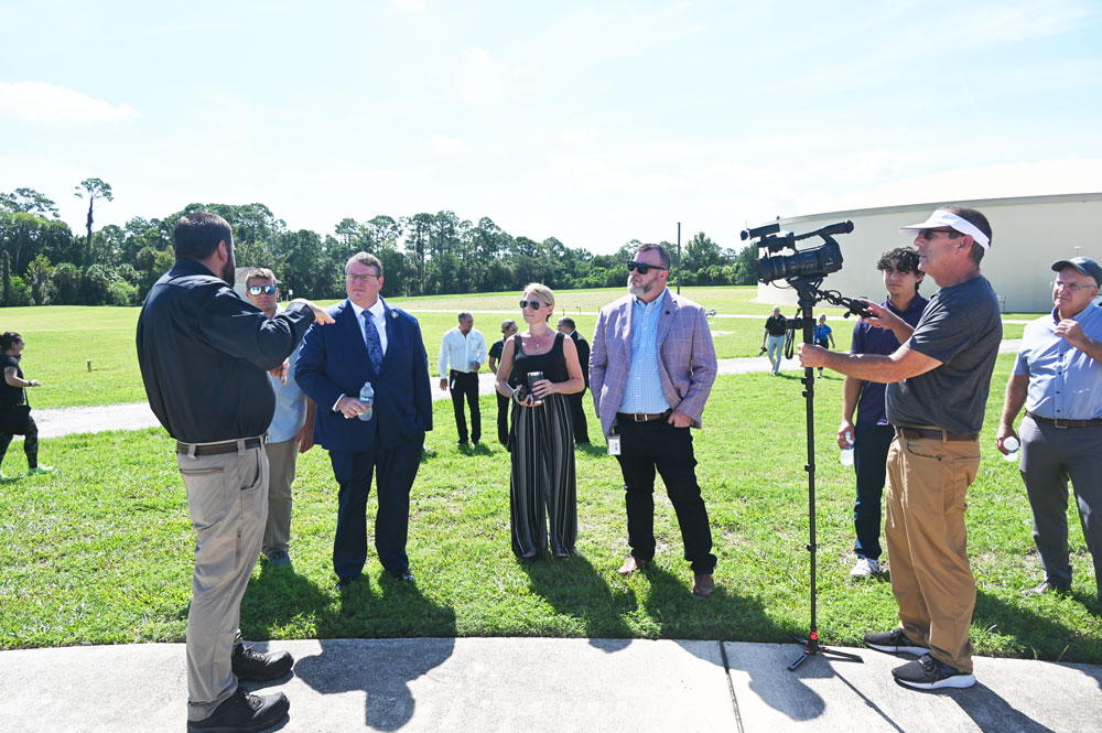 Palm Coast City Council member Theresa Pontieri, center, with Council member Ty Miller, right, during a visit by U.S. Rep. Randy Fine, left, at the city's Wastewater Treatment Plant 1 last August. Pontieri is seeking stronger local controls on the utility, should it become subject to a sale. (© FlaglerLive)