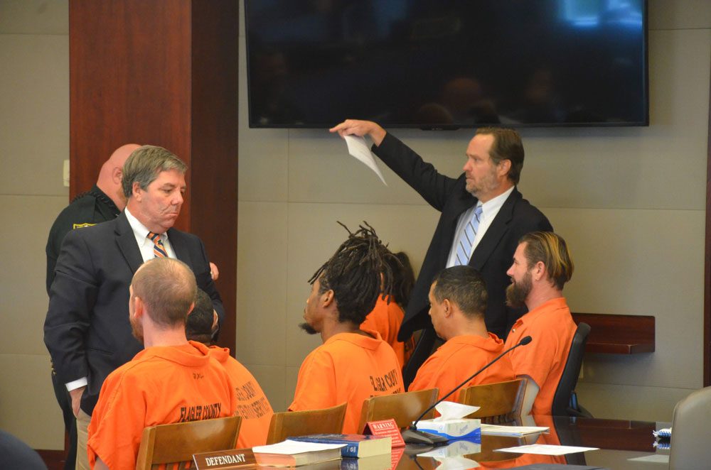 Defense attorneys speaking with their clients during  recent pre-trials at the Flagler County courthouse. (© FlaglerLive)