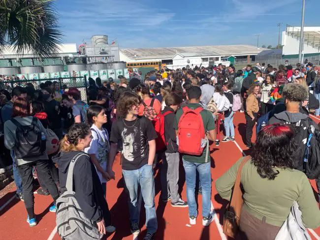 Hundreds of students walked around the track at Flagler Palm Coast High School this morning in a walkout organ ized by student-leader Jack Petocz to protest a bill that would restrict what educators may discuss with students. (© FlaglerLive)