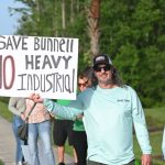 One of about two dozen protesters who demonstrated outside the Government Services Building last June before a Bunnell City Commission meeting, when they thought the rezoning of over 1,200 acres to industrial was on the agenda. There were no demonstrators before Monday's meeting, when it was on the agenda, but a sizeable crowd turned up to oppose it. The commission voted for the rezoning, 4-1. (© FlaglerLive)