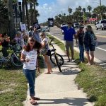 Demonstrators protesting the governor's plan to build hotels and golf courses and pickleball courts in state parks, outside Anastasia State Park today. (© Ken Bryan for FlaglerLive)