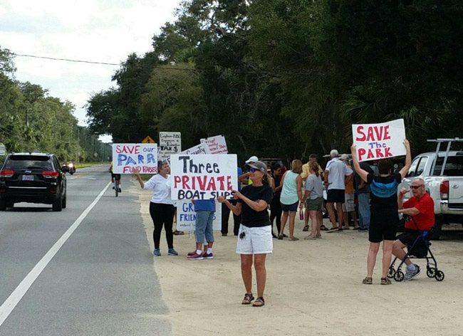 Opponents of an expanded Bing's BBQ have continued to protest outside B ing's Landing every Sunday, as they did on Feb. 24, ahead of county commission meetings on Wednesday that ended up cancelled. (© FlaglerLive)