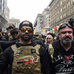 Enrique Tarrio, leader of the Proud Boys, at left, and group member Joe Biggs were sentenced to many years in federal prison. (Stephanie Keith/Getty Images)