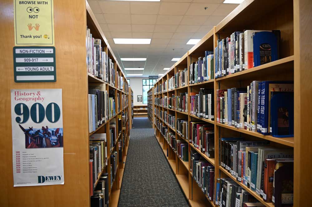 Stacks at the Flagler County Public Library, where hours are being reduced slightly, and simplified. (© FlaglerLive)