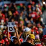 QAnon supporters wait for Donald Trump to speak at a campaign rally at Atlantic Aviation on September 22, 2020, in Moon Township, Pennsylvania.